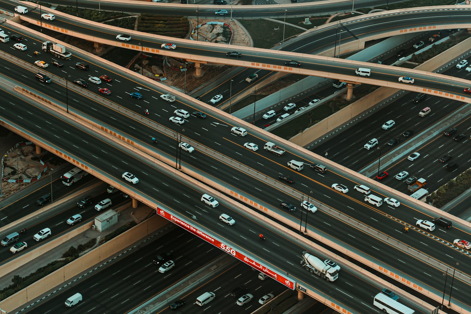A busy highway interchange at dusk with traffic flowing across multiple ramps, illustrating how enterprise AI architecture routes requests across models and agents inside a governed on-premises environment