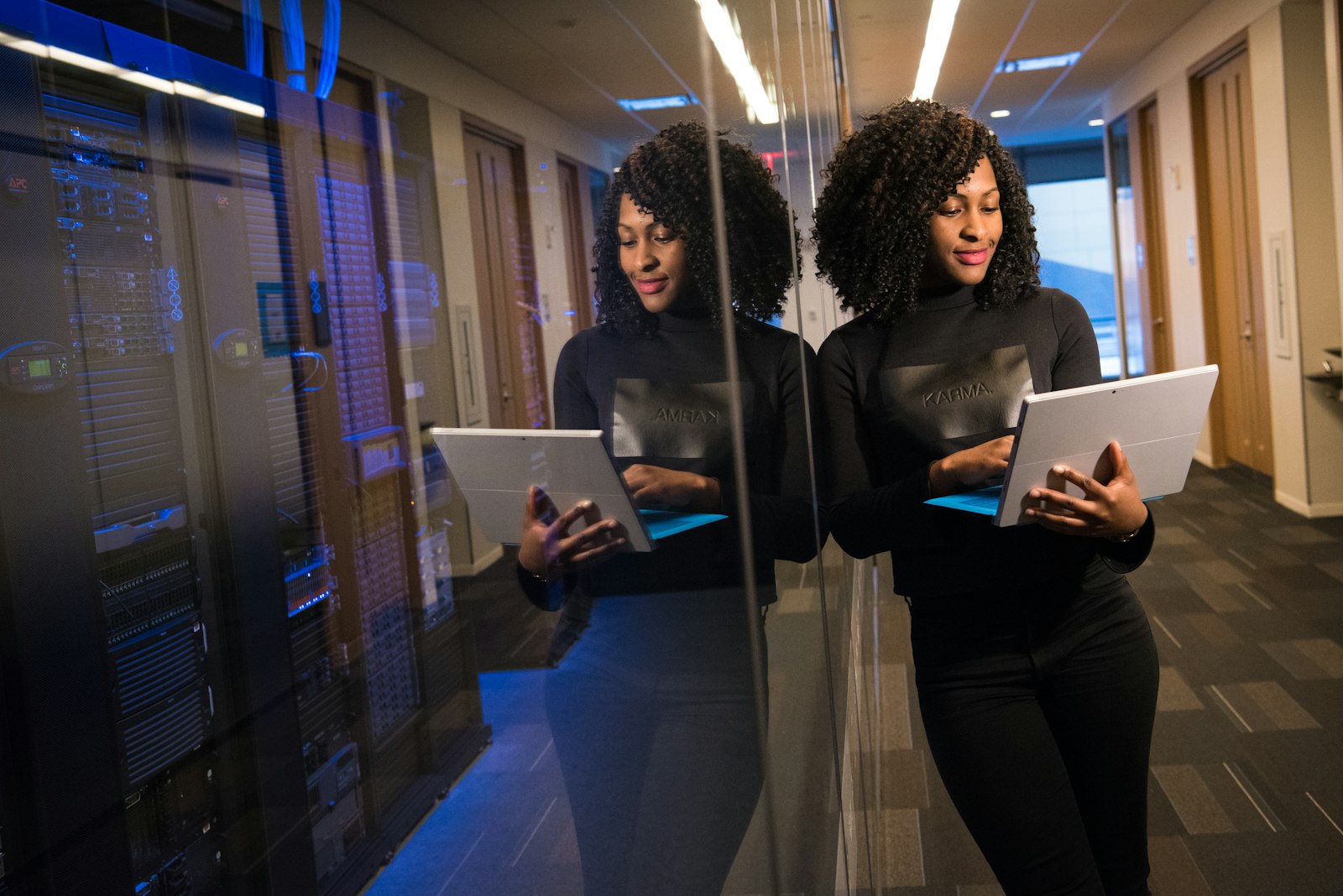 An enterprise operations professional reviewing customer records on a laptop, representing an onboarding team supported by governed AI agents that verify documents inside the organization's own on-premises security boundary