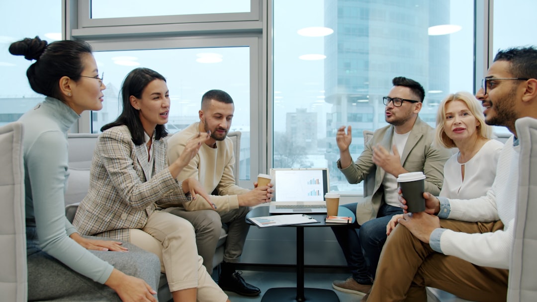 A diverse team meeting in a modern office, representing the administrative and operations staff whose healthcare workflows AI agents support inside a governed, private infrastructure