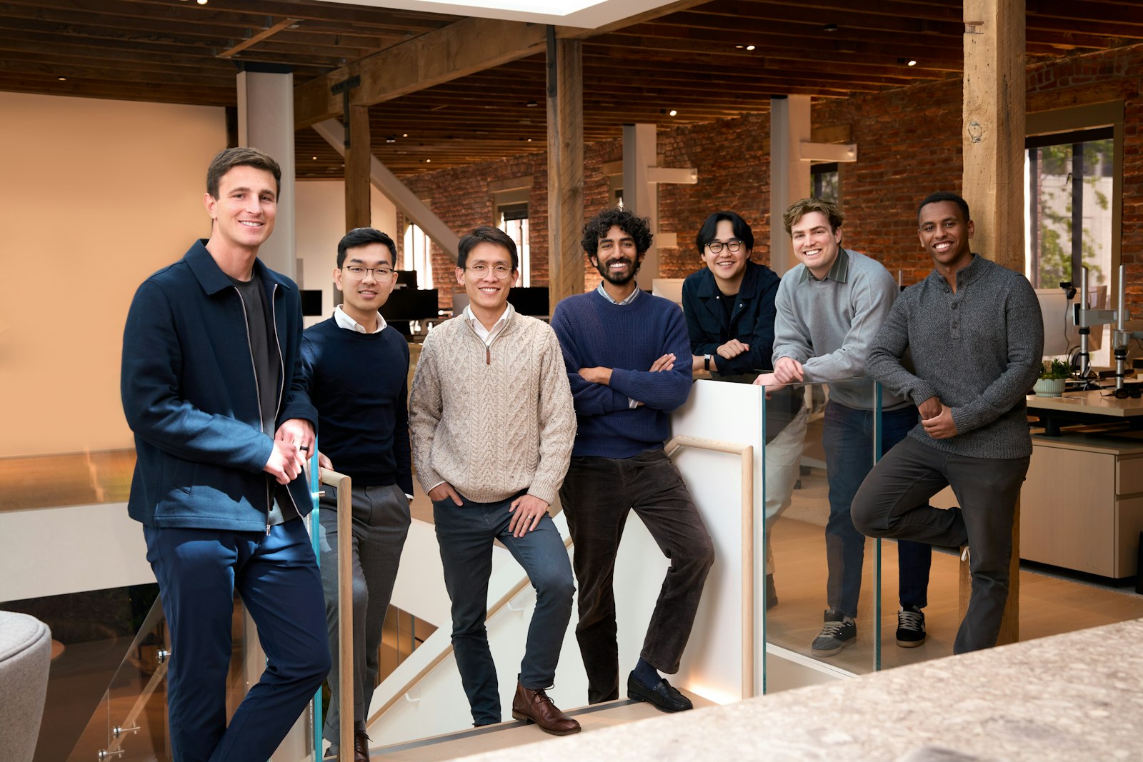 A group of colleagues standing together in a modern office, representing the insurance policy servicing teams whose endorsement, renewal and cancellation workloads are supported by governed on-premises AI agents