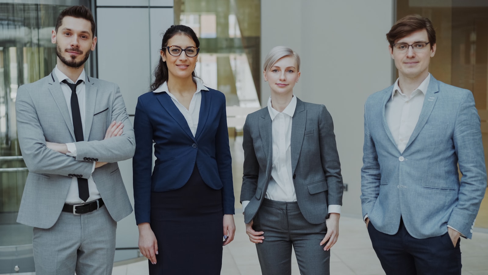 Four business professionals reviewing work together indoors, representing the human review and oversight layer that governs AI agents in on-premises loan underwriting workflows