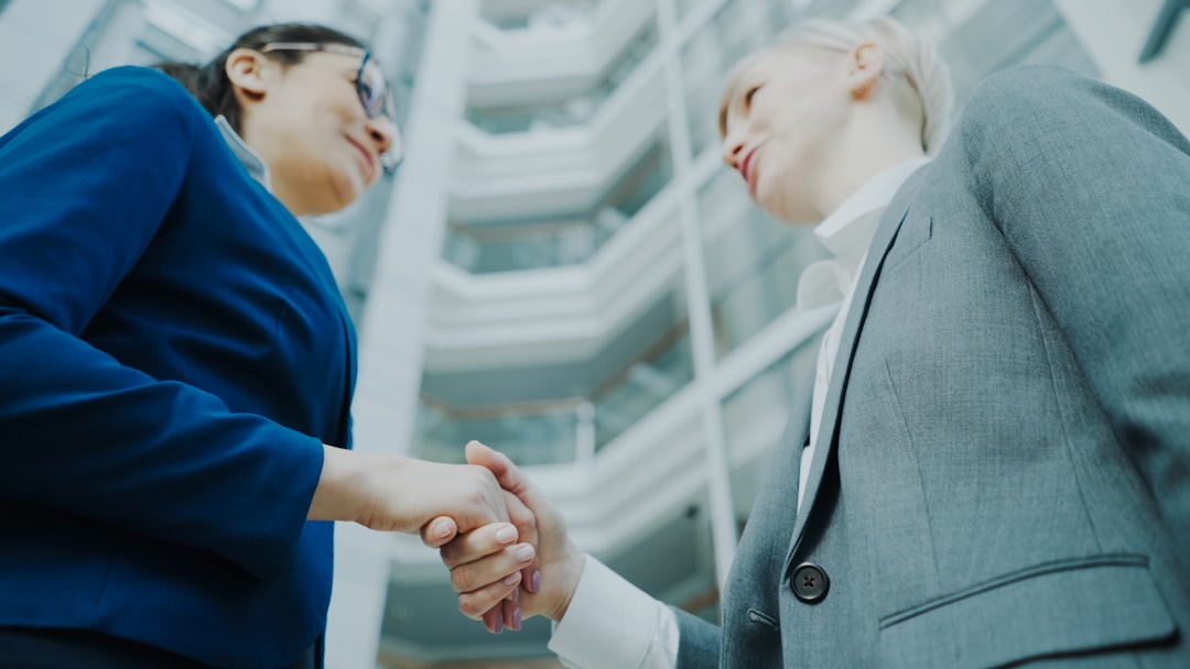 Two banking professionals meeting in a modern office, representing the trade finance operations teams whose documentary credit examinations can be prepared by governed on-premises AI agents