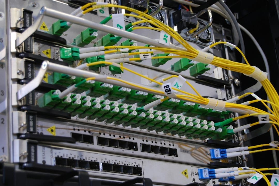 Fibre optic cables plugged into a network switch in a server rack, a picture of the many system connections an AI agent reaches through its tools