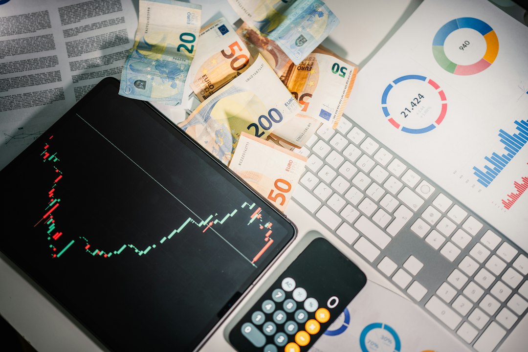 Euro banknotes, a tablet showing a price chart, a calculator and printed financial reports on a desk, representing the capital and operating budget decisions behind on-premises AI infrastructure
