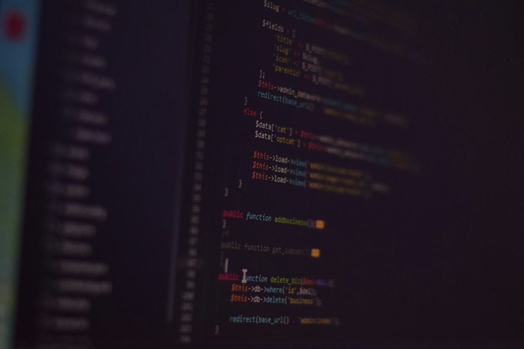 Out-of-focus source code glowing on a dark editor screen, standing in for a terminal coding agent talking to a model on the same machine