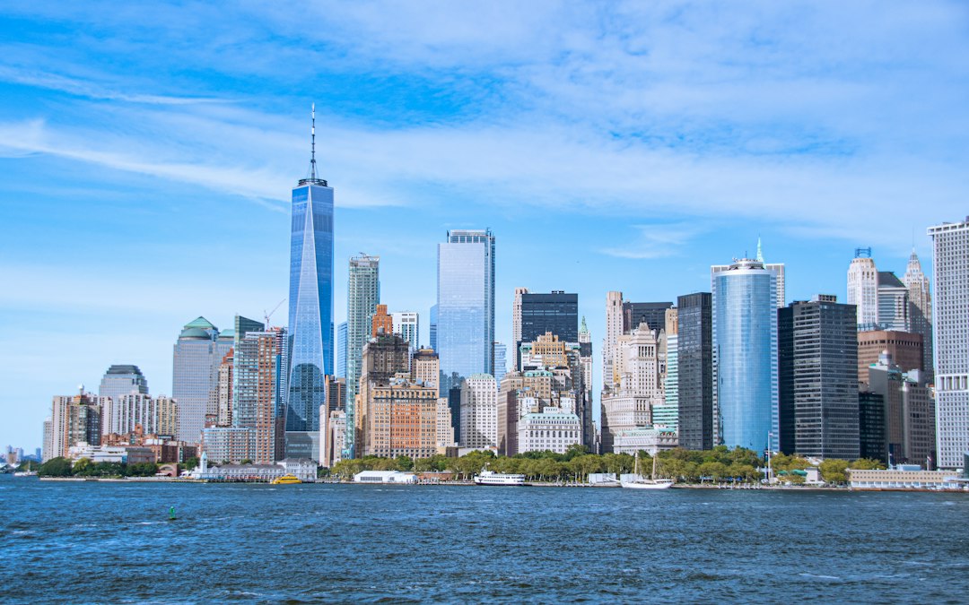 The Lower Manhattan skyline seen across the water on a clear day, standing in for US companies whose AI products reach the European market