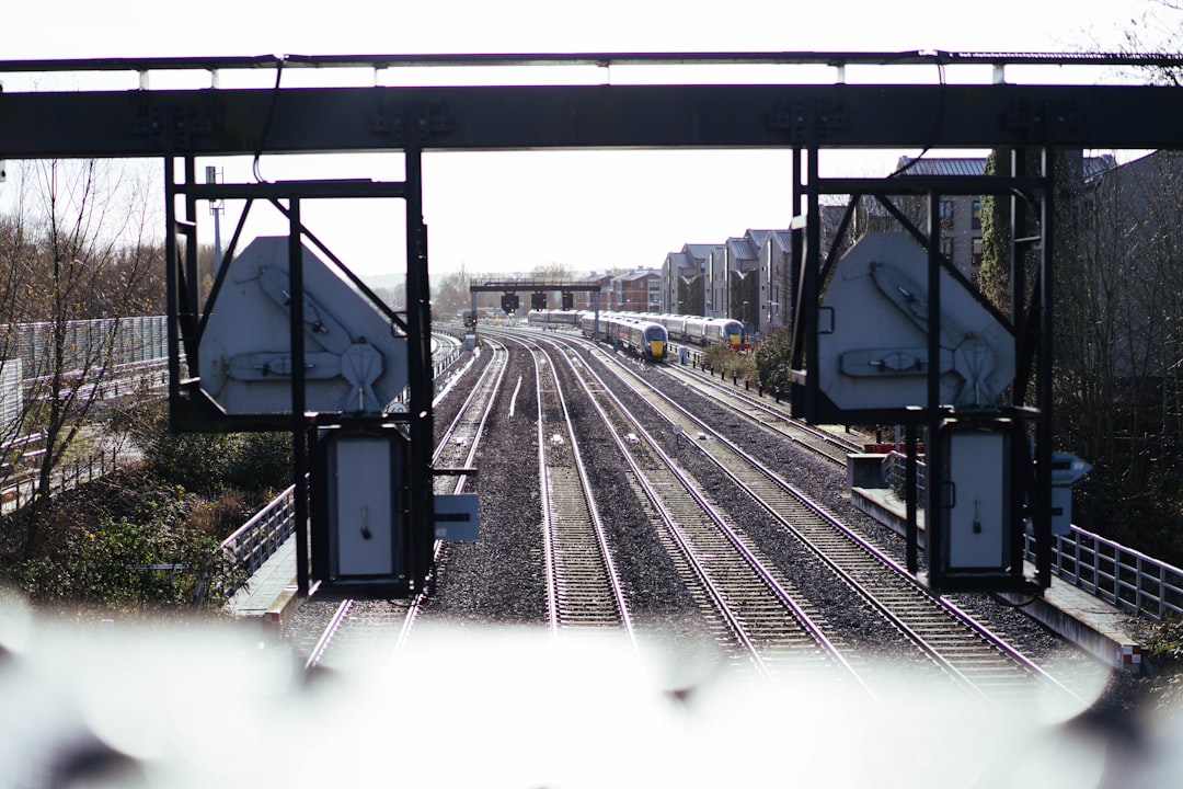 Railway tracks converging into a city under overhead signals, illustrating how an enterprise AI platform decision sets the path a company can later switch off of — the core question when evaluating vendor lock-in