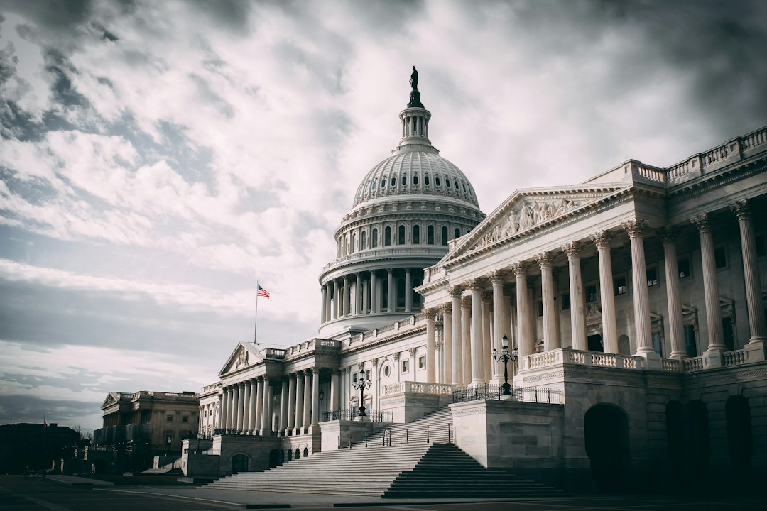 The United States Capitol under a cloudy sky, seen from the side of the building