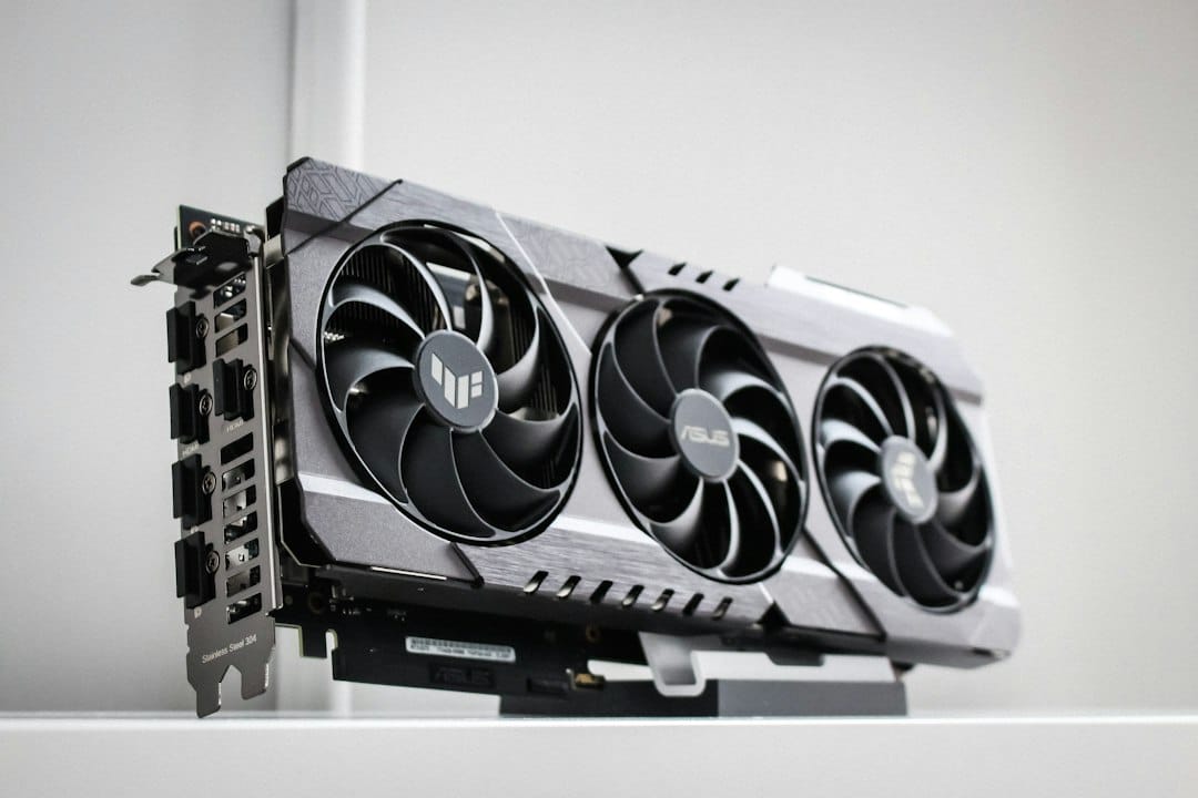 A triple-fan graphics card standing upright on a white surface, the kind of single GPU that the smaller Gemma 4 sizes are built to run on