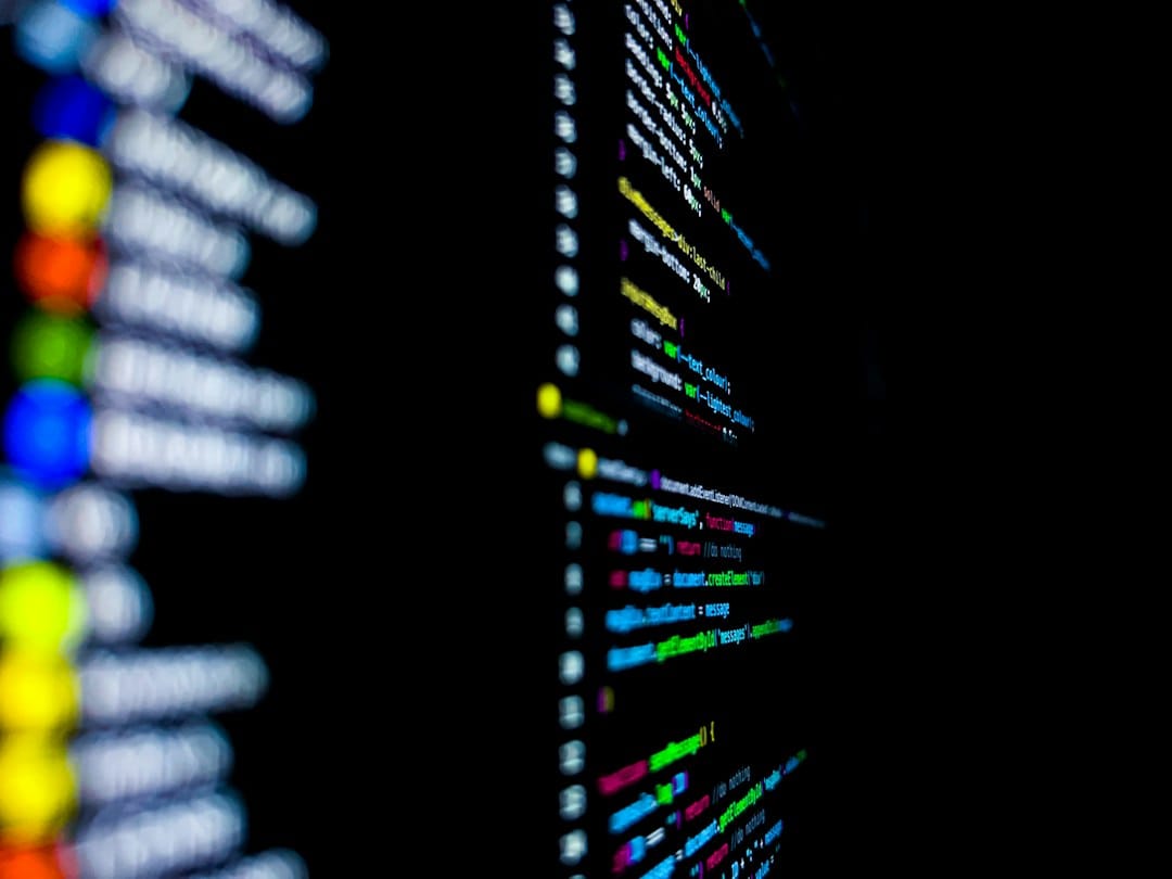 Out-of-focus lines of colour-highlighted code on a dark monitor, standing in for the terminal commands that install and serve gpt-oss on local hardware