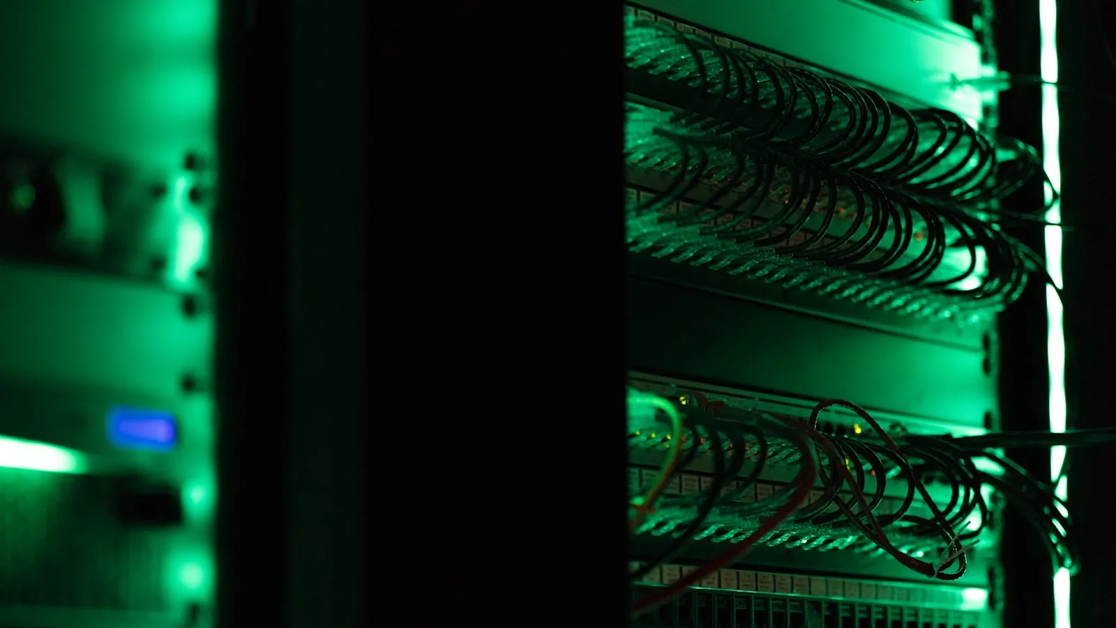 Rack of enterprise server equipment in a dark data hall, the infrastructure layer that gates on-premises AI deployment schedules