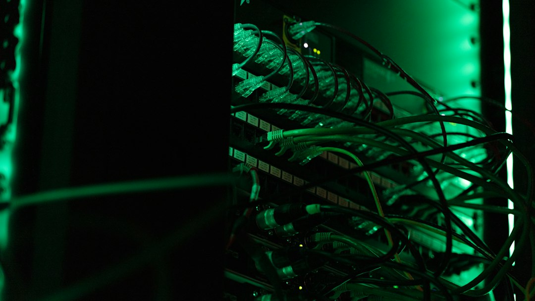 Network cables patched into a server rack under green light, representing the on-premises infrastructure where hybrid keyword and vector search run for a private RAG pipeline