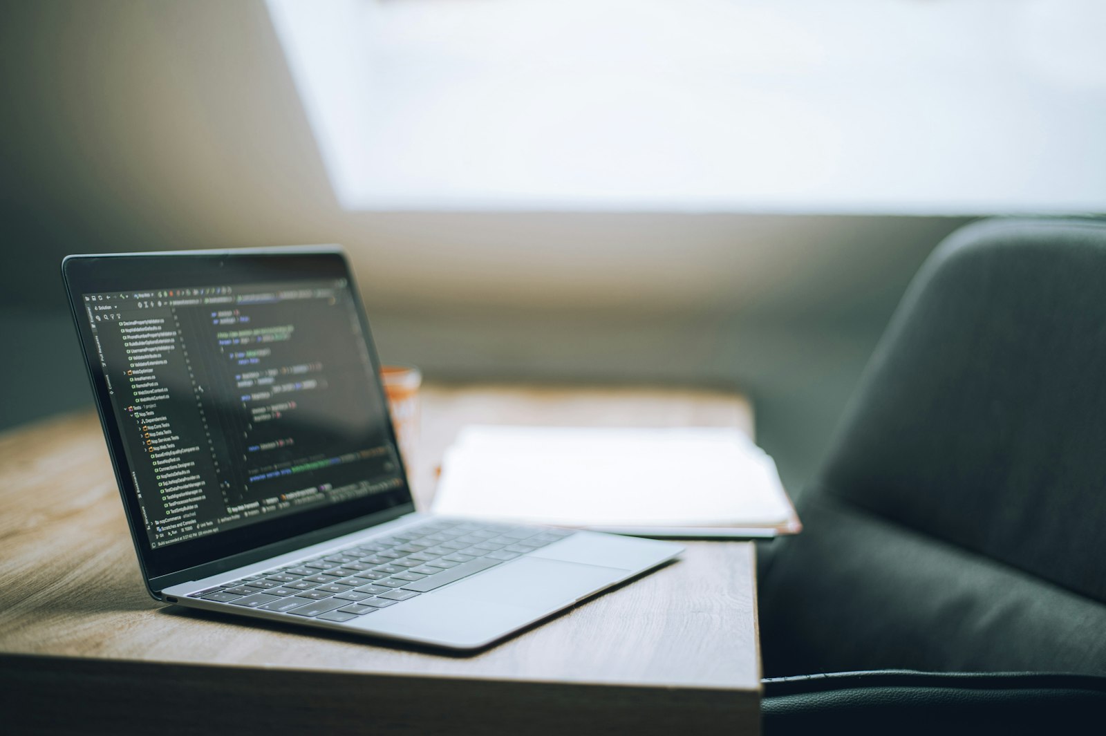 A laptop displaying source code on a wooden desk, representing the developer-framework layer that LangChain provides and the gap between it and a governed on-premises enterprise AI agent platform