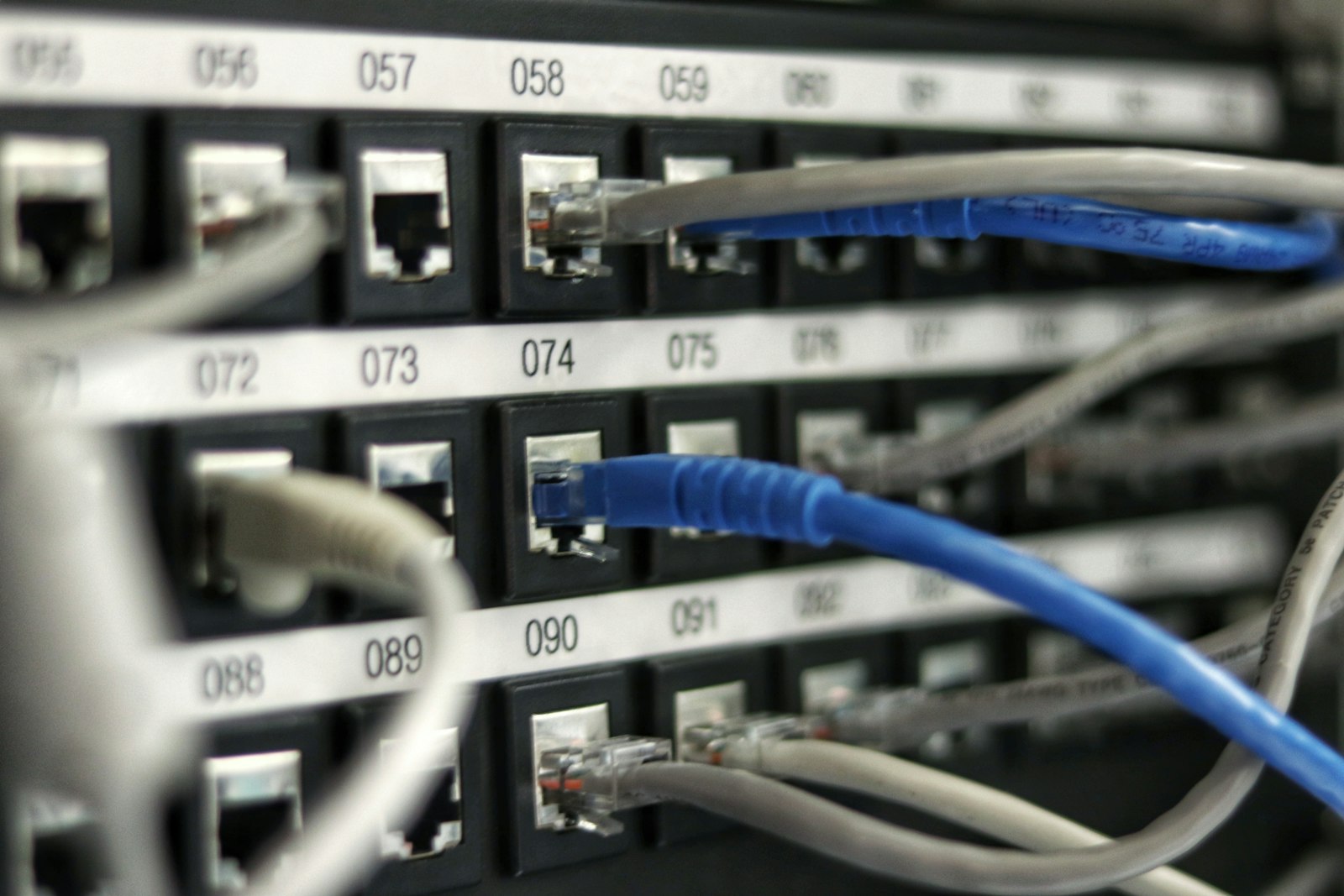 Blue network cables routing through enterprise infrastructure, representing governed model routing that directs each AI request to the right local model inside an organization's own on-premises environment