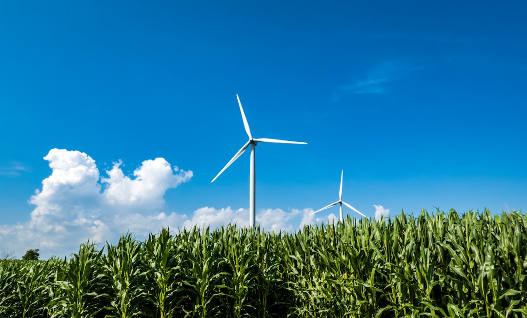 Wind turbines beside agricultural fields representing sustainable AI energy and on-premise orchestration