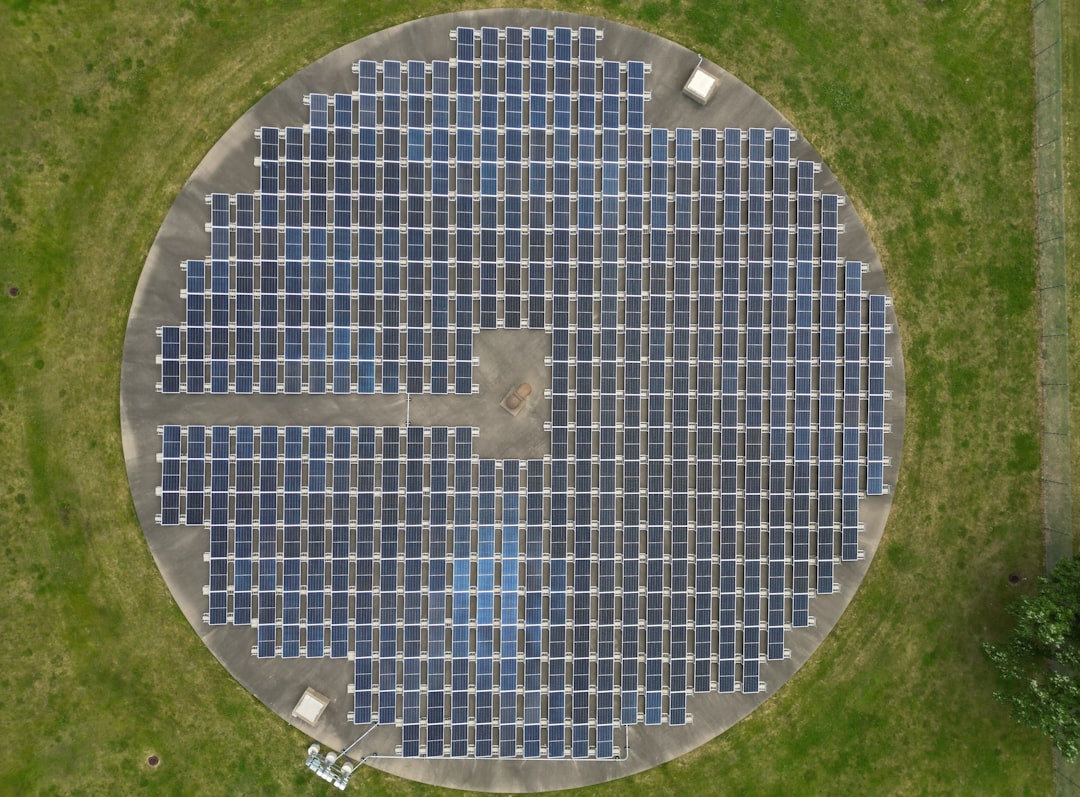 Aerial view of a circular solar panel array on green grass — representing energy infrastructure and the intersection of renewable power generation with sovereign on-premises AI platforms