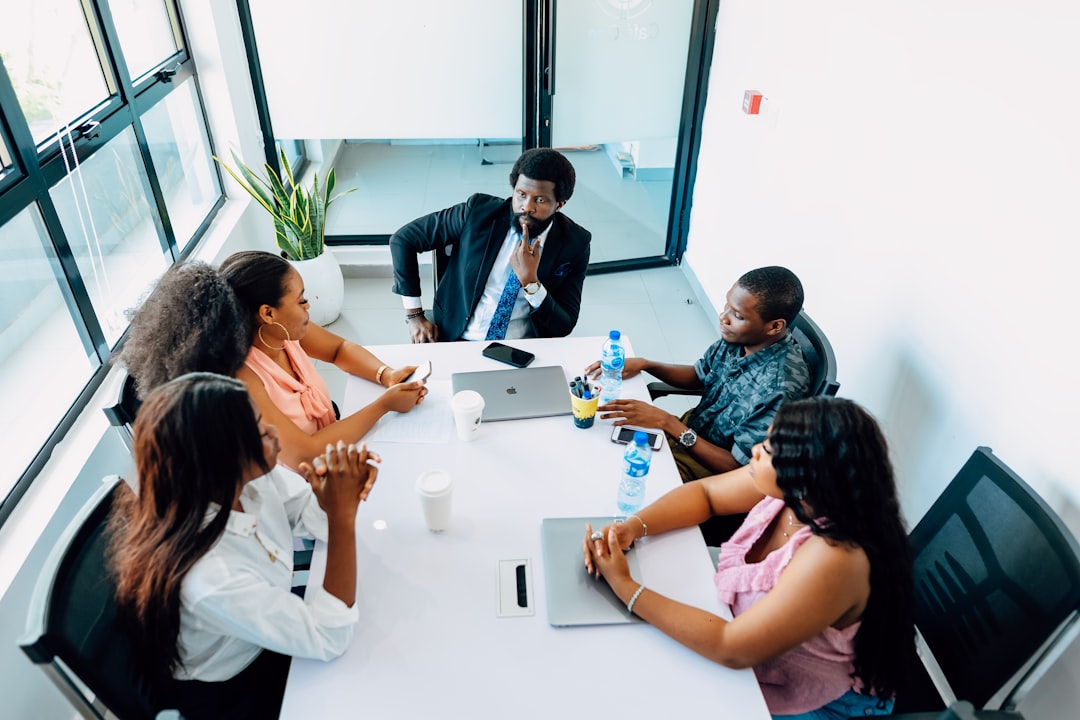 Business executives sitting around a modern conference table in discussion — representing C-suite and board-level decision-making on private AI investment strategy and enterprise technology